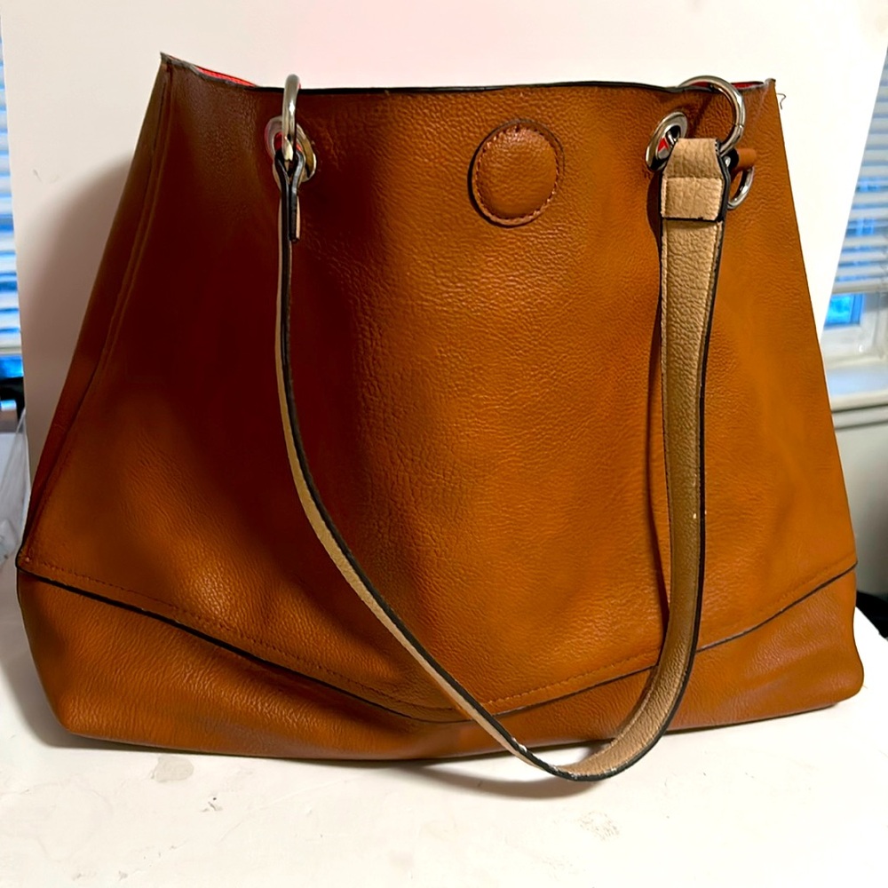 Super cute  bag brown on the outside coral on the inside
